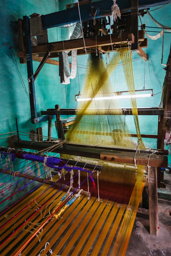 Man Weaving Silk Sari on Loom in India